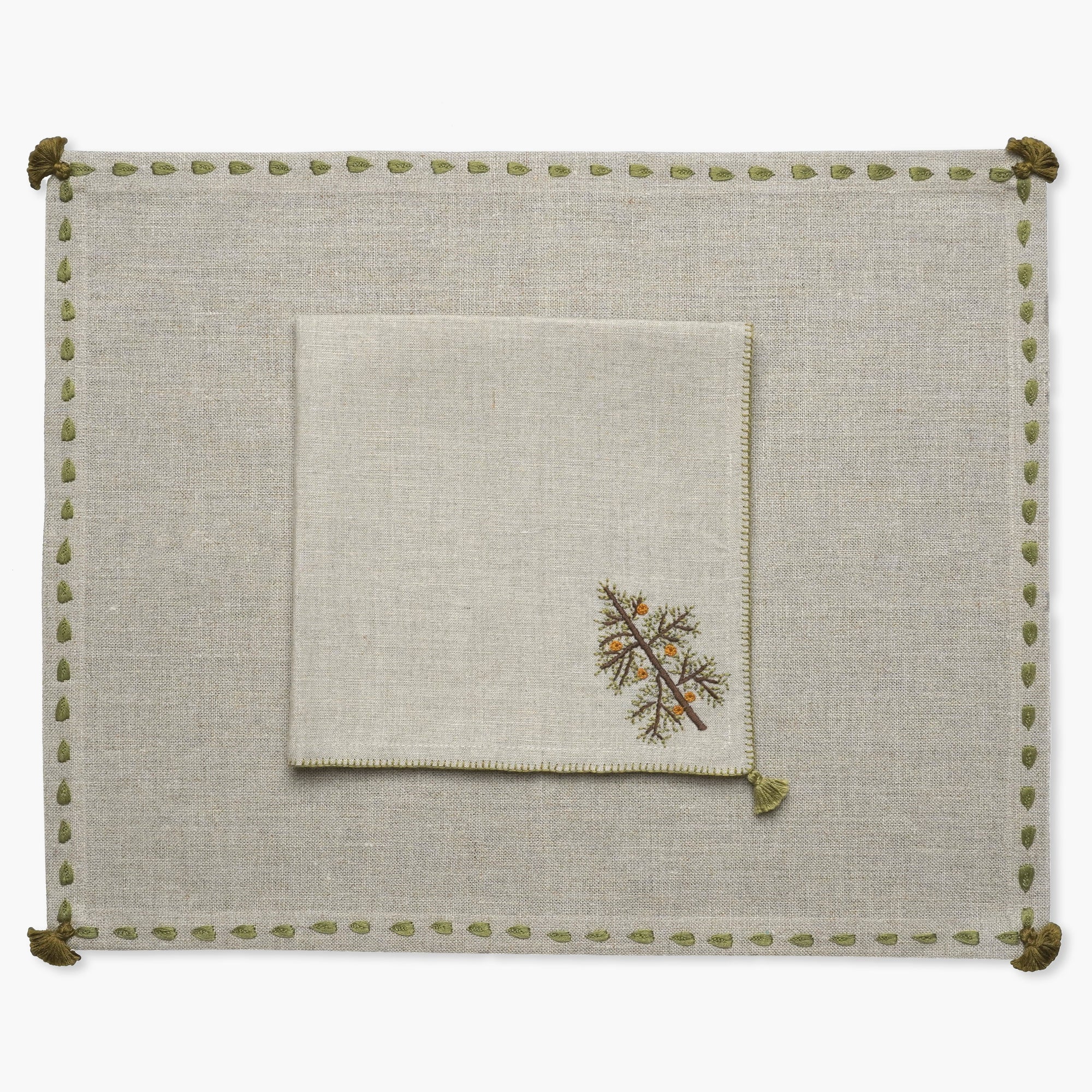beige linen table napkin hand embroidered with Christmas tree design from artha collections