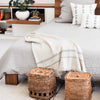Neutral color throw pillows and baskets for the bedroom from artha collections