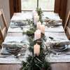 Festive table decorations with cream linen placemats and napkins by Artha Collections