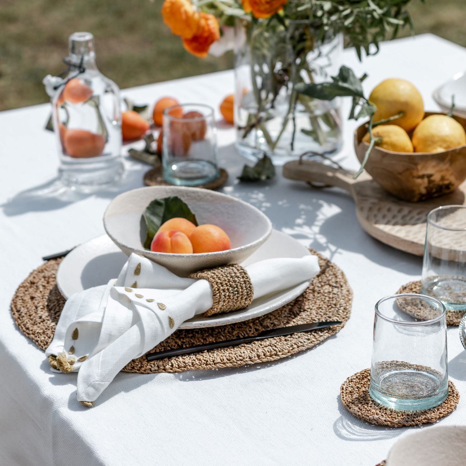 Summer table setting with round hand crocheted placemats made from banana fiber rope for Artha Collections