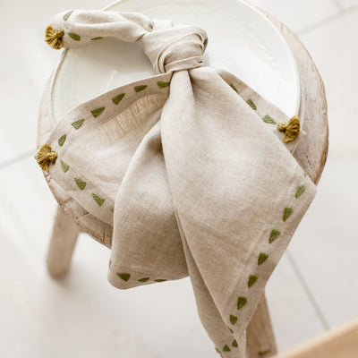 beige linen napkin sage green border knotted from artha collections