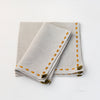 Beige linen napkin set hand embroidered with saffron yellow border from Artha Collections