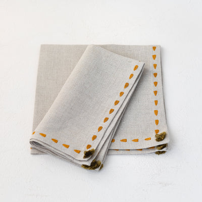 Beige linen napkin set hand embroidered with saffron yellow border from Artha Collections