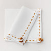 Cream linen hand embroidered napkin set with saffron border from Artha Collections