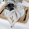 beige linen napkin with evergreen branch motif by artha collections