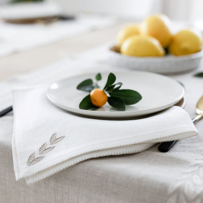 Cream linen napkin with petal hand embroidery from Artha Collections