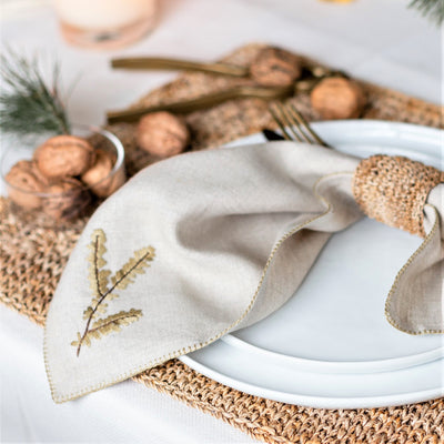 beige linen folded napkin with branch motif hand embroidery by artha collections