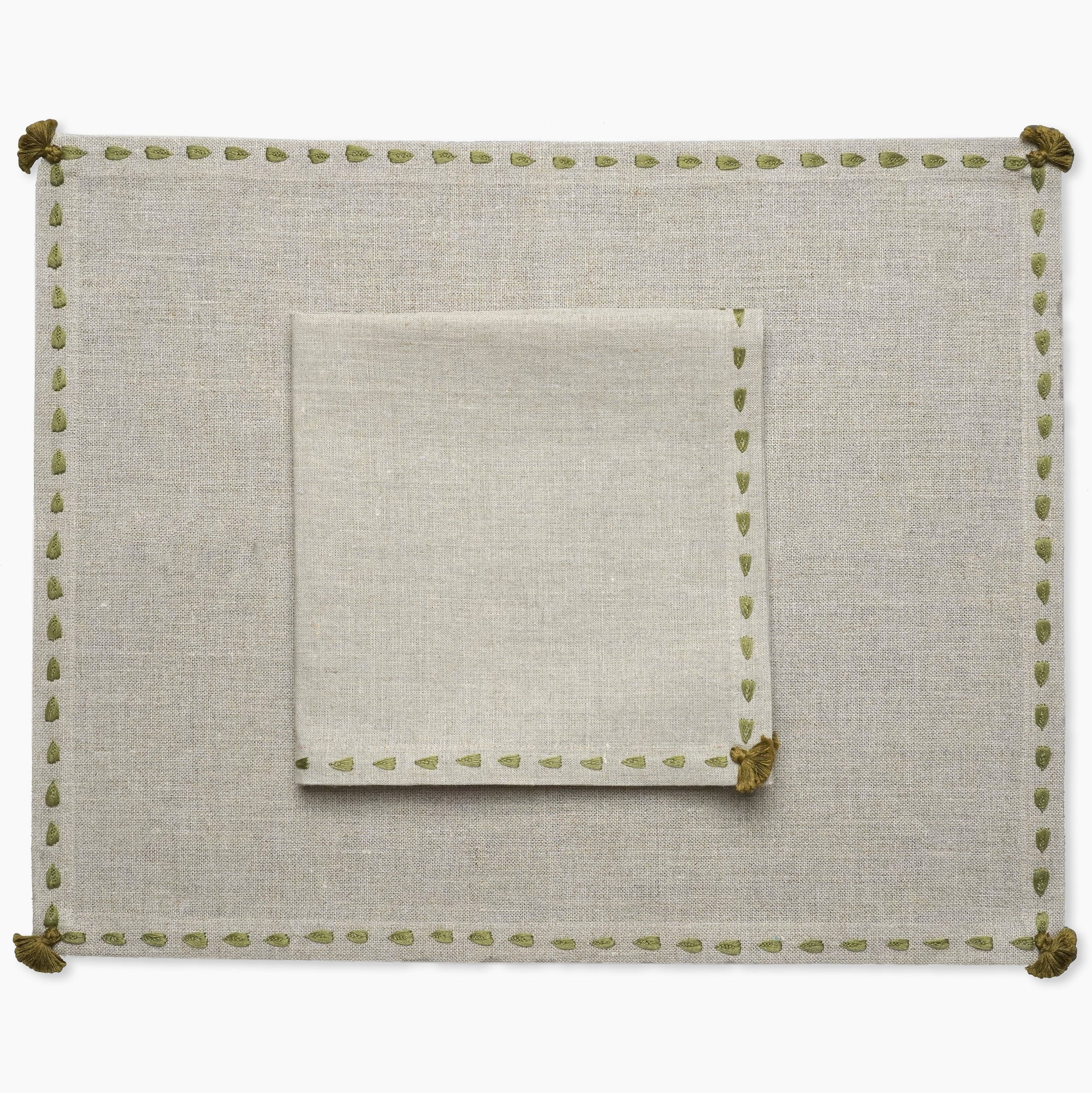 Beige linen placemat with green hand embroidered border from artha collections