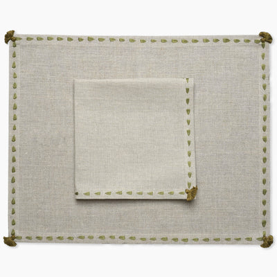 Beige linen placemat with green hand embroidered border with matching napkin from artha collections