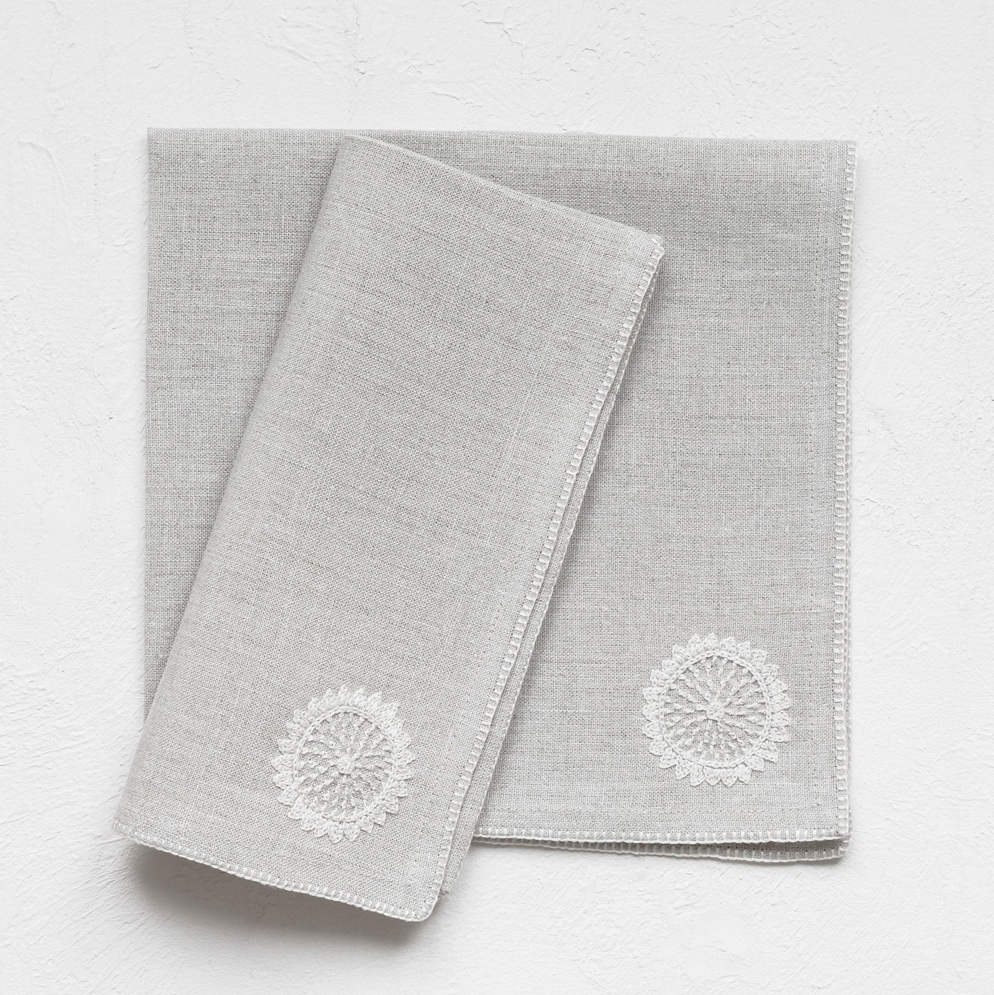 Beige linen napkins with Surya sun design from Artha Collections