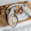 beige linen folded napkin with branch motif hand embroidery by artha collections