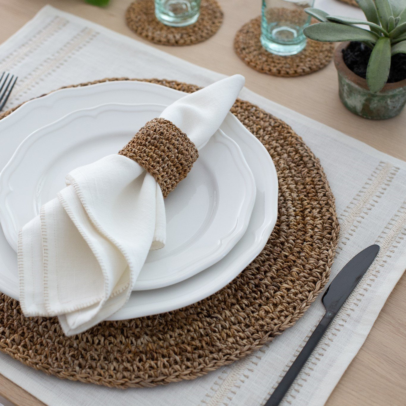 Summer table setting with round hand crocheted placemats made from banana fiber rope for Artha Collections